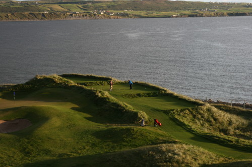 The 6th green at left, a golfer tees off on No. 7 at Lahinch Golf Club in Ireland.