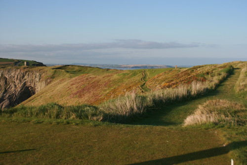 No. 12 at Old Head; the fairway is over the rise, and the green is tucked above the edge of the rocky cliff.
