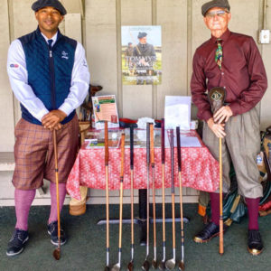 Durel Billy stands by exhibit of hickory golf clubs