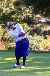 Durel Billy hits a golf shot at a hickory golf tournament